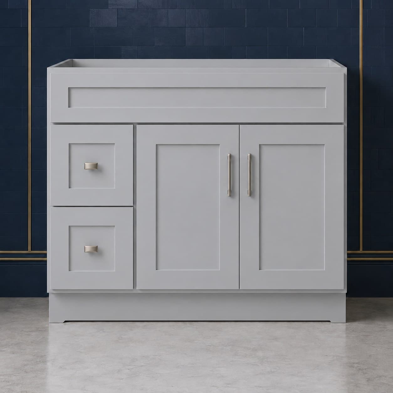 42-inch wide vanity sink base cabinet with a left-side two-drawer stack beside two shaker-style doors topped by a false drawer front, neutral finish, in Silver Gray finish — front view